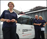 presenters standing next to radio car