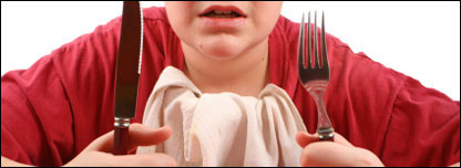 A person sitting at the table ready to eat