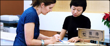 A woman checks in to a hotel