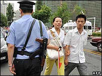 A couple pass police in People's Square