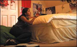 Girl in bedroom with Beckham posters