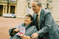 Image: Lin Berwick with her husband Ralph receiving her MBE at Buckingham Palace