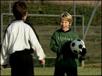 Two children playing football