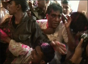 Minister Dr. Mervyn Silva being taken away by security forces