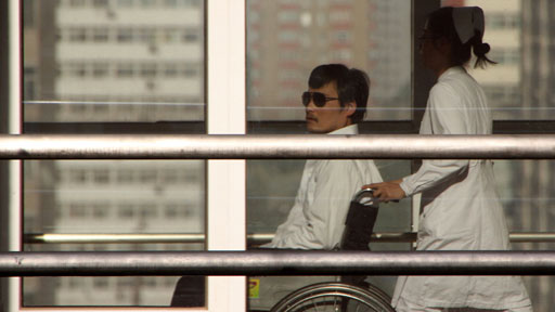 Chen Guangcheng is seen beeing pushed in a wheelchair by a nurse