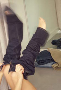 Woman putting on jeans