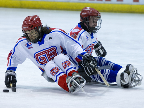 Two players tussle for the puck. Taken by On Edition Photography