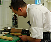 Seth Ward cutting bread