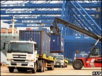 Shipping containers being loaded on to lorry