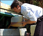 Richard puts sunflower oil into the filter tank