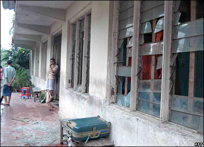 Remains of broken glass litter the pavement after Security Forces raised a monastery in the eastern part of Rangoon.