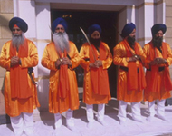 Sikhs guards with swords wearing traditional dress