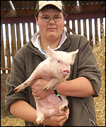 Matthew Horsley with a piglet