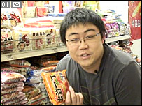 Pei (Nick) Wu holding noodles