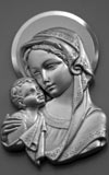 Mary and the baby Jesus depicted in metal relief