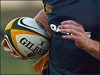 Player carrying rugby ball
