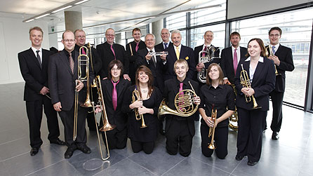 John Whittaker, Chairman of Peel Holdings, and Sir Michael Lyons, Chairman of the BBC Trust, with members of the Salford Family Orchestra at the handover of Building C at MediaCityUK, Salford (photo: Ed Swinden)