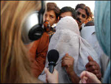 Jill McGivering and Caroline Finnigan interviewing a woman who has lost her house and belongings in the floods and complains that she is not getting aid