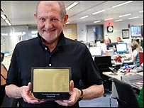 Tony Butler, with award, in the BBC WM newsroom
