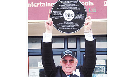 Photograph of Joe Flannery holding a plaque in Prestatyn