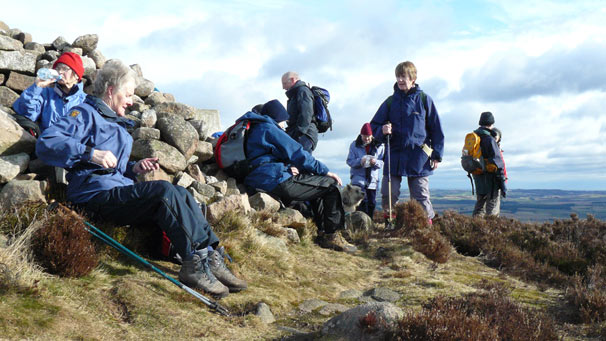 Walkers take a break beside summit cairn