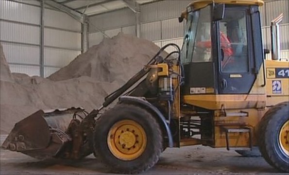 Road grit being moved by a digger