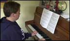 teenage boy playing the piano