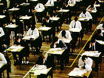 Students sitting an exam in a school hall