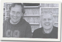 Mark McCann (chwith) ac Owen Hughes tu ôl i'r cownter