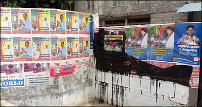 Ruling party campaign poster in Jaffna were intact while others were tarred (photo: Charles Haviland)