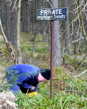 Man working by sign, 'Private Pittodrie Estate'