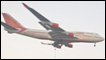 A jumbo jet flies over Mumbai.