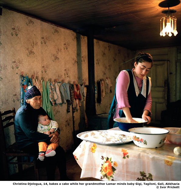  Christina Djologua, 14, bakes a cake while her grandmother Lamar minds baby Gigi, Tagiloni, Gali, Abkhazia
