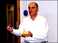 Tim trying his hand at juggling