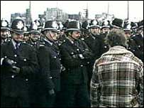 Striking miner and police line