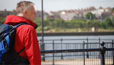Derek walking along the waterfront
