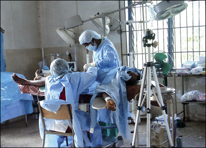 Doctors perform an operation with scant resources