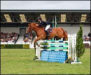 Off to a good start - a rider clears fence one