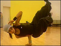 H doing a breakdancing move