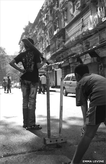 Boys playing cricket in the street