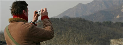 Man taking photo of Great Wall of China