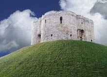 Round stone castle keep on a motte (mound of earth)