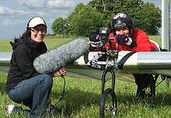 Reporter Tracey Logan with Dr Bill Brooks, testing his pedal-powered plane.