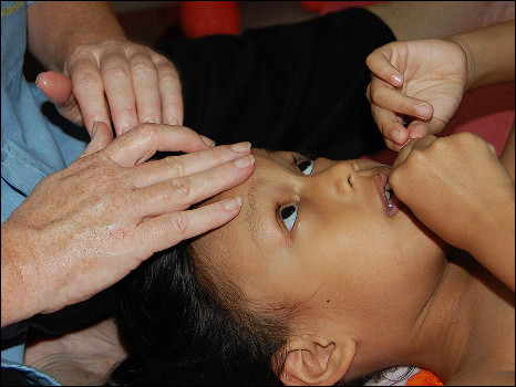 Massage trainer demonstrating rehabilitation techniques. 