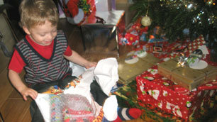 Laurence Clark's son, Tom, excitedly opening his Christmas presents last year