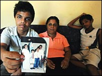 Sandhya Eknaligoda with two sons holding a photo of Prageeth (file photo)