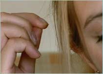 Woman pulling a hair out