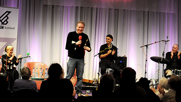 Producer Rob Pearson doing a great job of warming-up the Festival Cafe crowd!