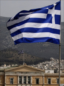 Greek flag and parliament building in Athens