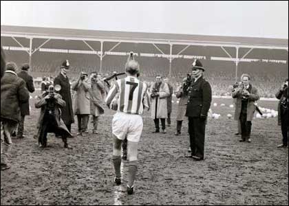 Sir Stanley walks out onto the pitch 